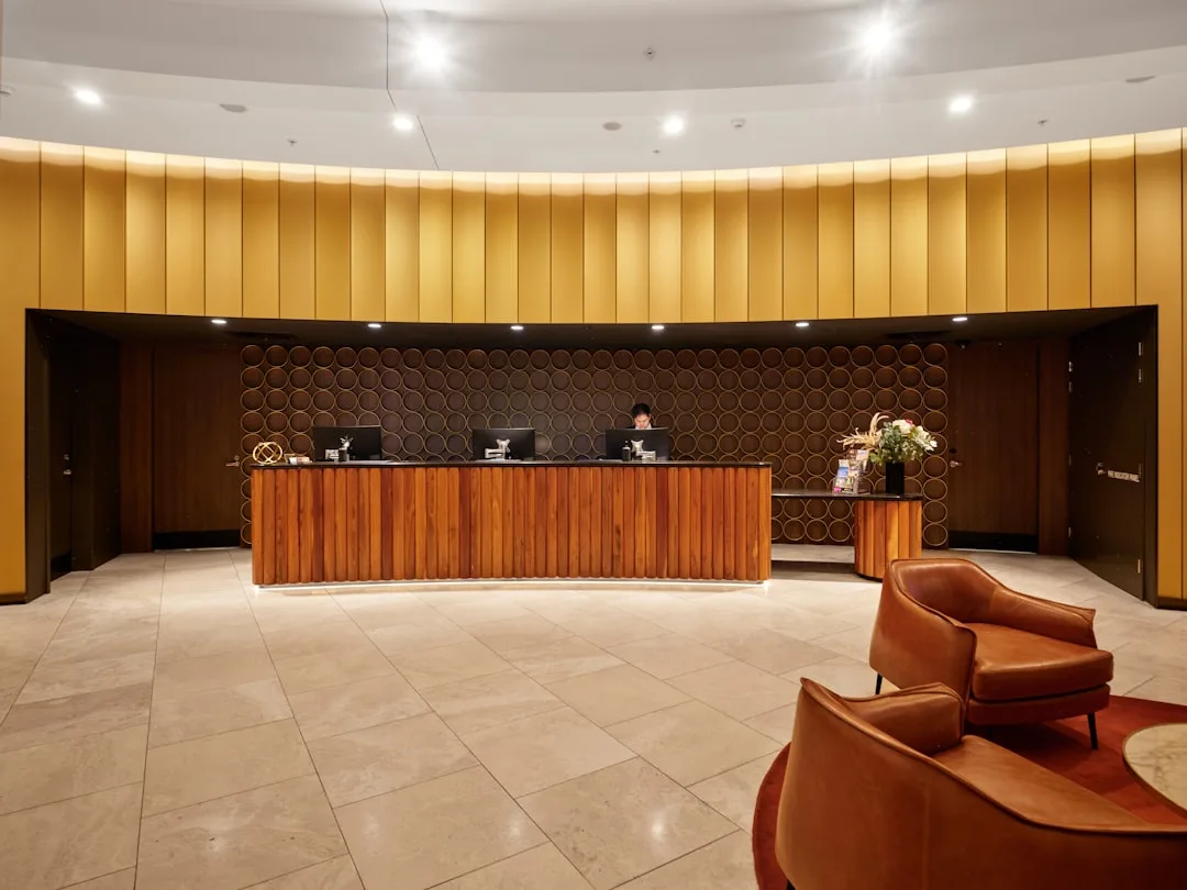 Elegant hotel reception desk with modern wooden design and concierge service