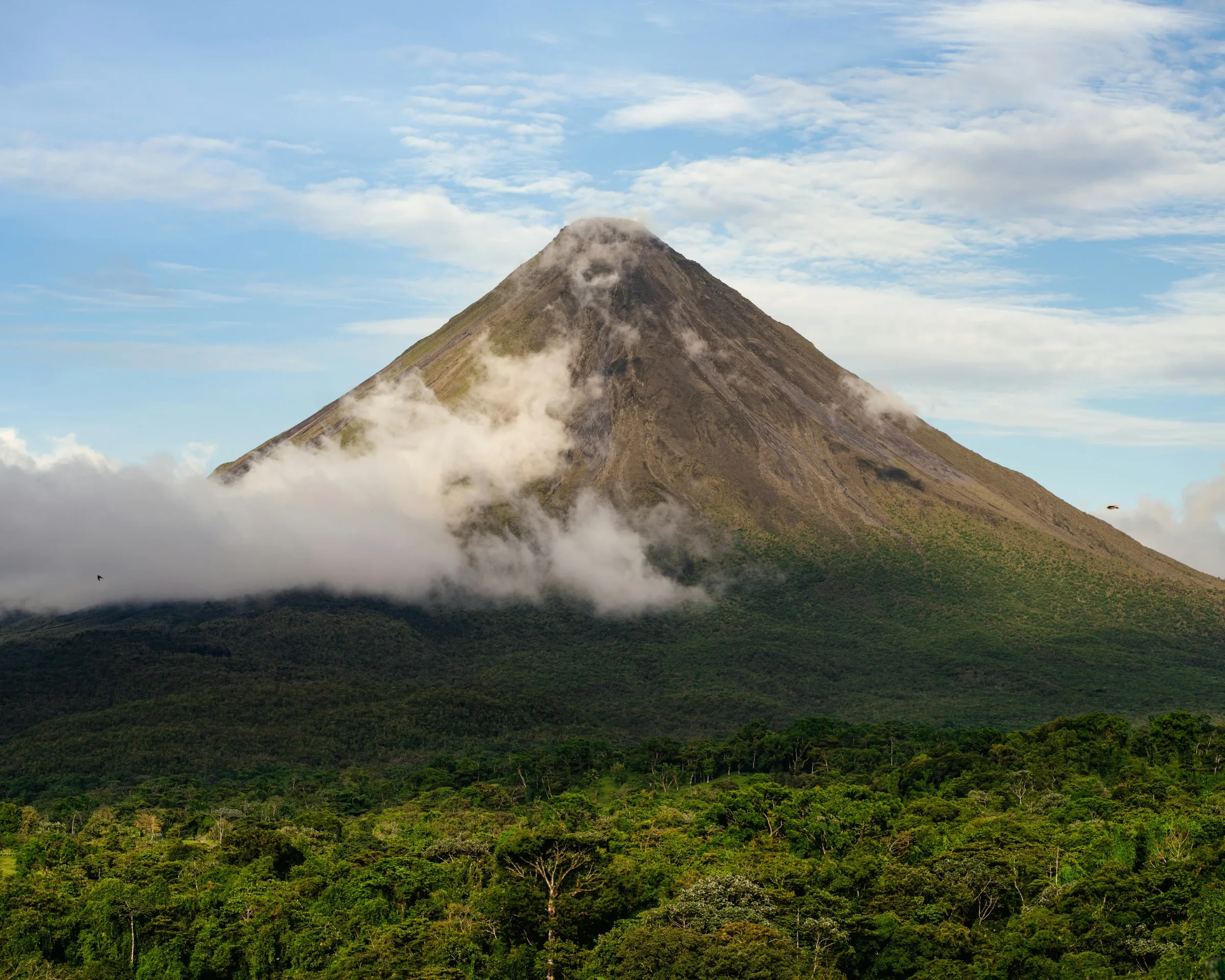 Arenal Volcano rising above tropical rainforest in Costa Rica
