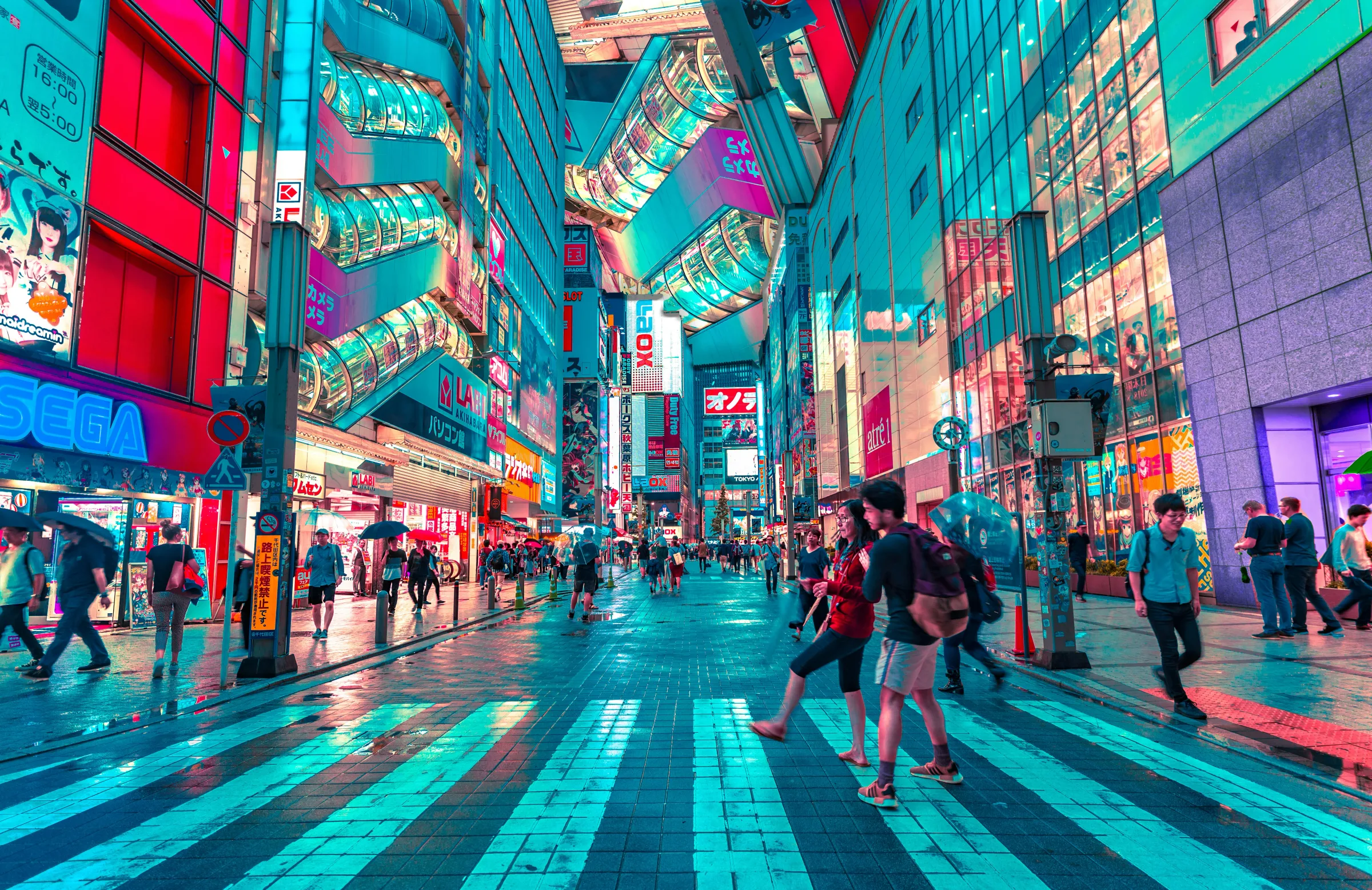 Neon-lit electronics and anime shops along a street in Tokyo's Akihabara district