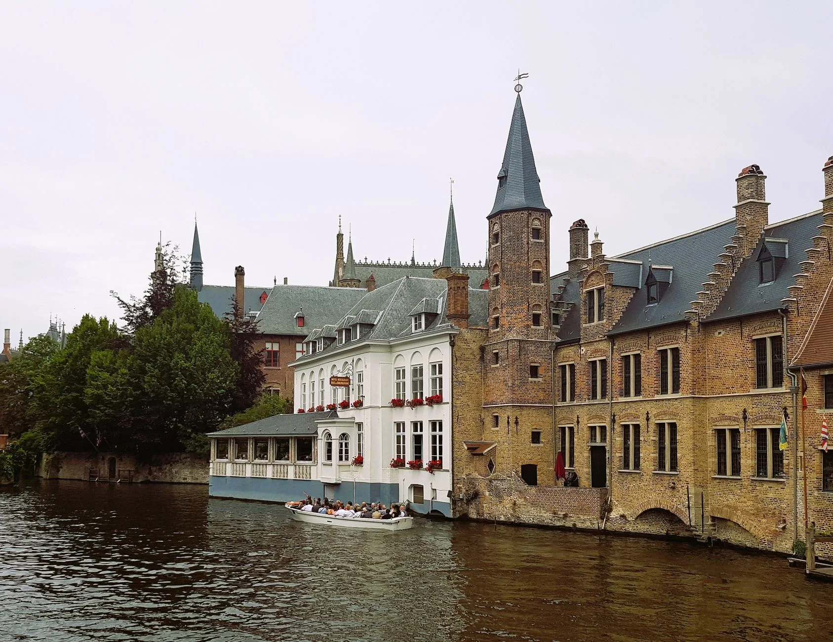 Historic canals of Bruges with medieval architecture reflected in the calm water