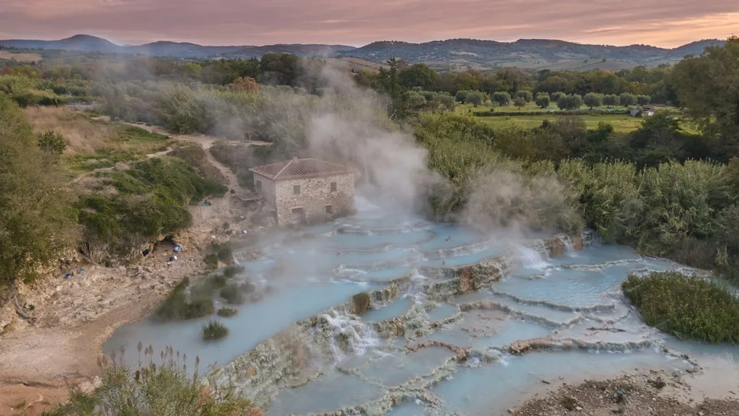 Steaming thermal springs with turquoise blue water in a Tuscan landscape